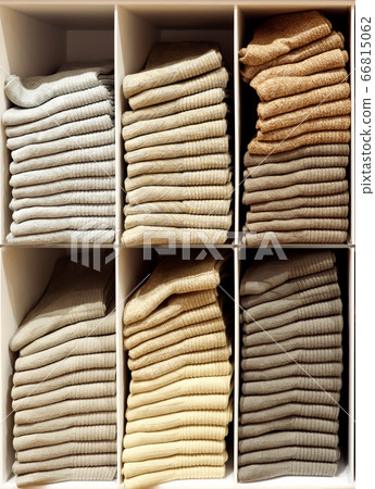 Shelves with evenly folded pastel-colored pullovers Shelves with evenly folded pastel-colored pullovers 66815062