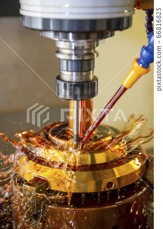 The CNC milling machine cutting the brass parts. The CNC milling machine cutting the brass parts. 66816825