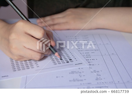 Students hand holding pencil writing selected Students hand holding pencil writing selected 66817739
