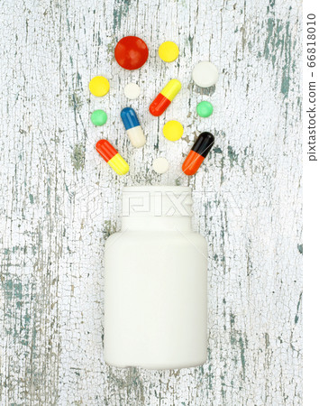 Color pills in the shape of heart on old wooden Color pills in the shape of heart on old wooden 66818010