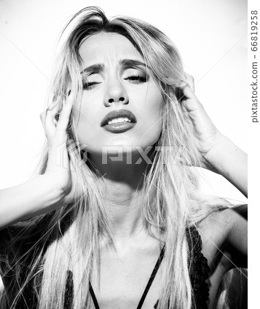 emotions and feelings concept - beautiful blond lady portrait in sexy lingerie while getting an orgasm on white background. Woman shouts in ecstasy in bright light in monocrome 66819258