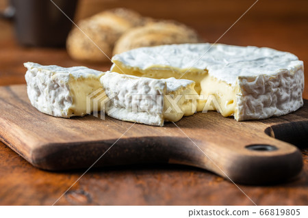 Brie cheese. White soft cheese with white mould. 66819805