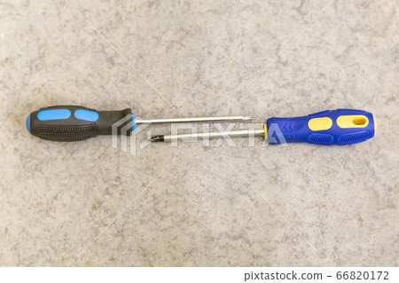 two screwdrivers on a light background lie two screwdrivers on a light background lie 66820172