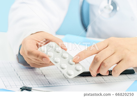Female doctor pointing at pills. Medicine and Female doctor pointing at pills. Medicine and 66820250