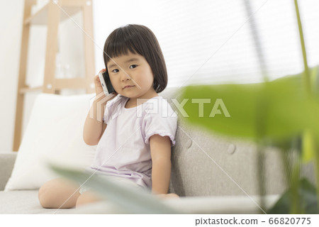 3 year old child making a phone call with a smartphone 66820775
