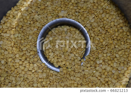 Toor dal filled steel bowl in pile of toor dal, 66821213