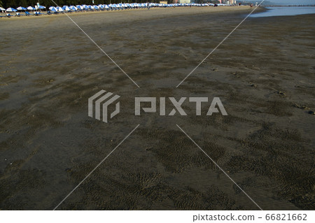 Cox's Bazar beach in Bangladesh People who enjoy swimming Beach umbrellas lined with low tide sea and sandy beach Cox's Bazar beach in Bangladesh People who enjoy swimming Beach umbrellas lined with low tide sea and sandy beach 66821662