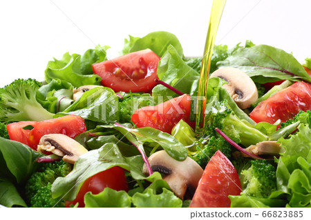 Apply olive oil to the salad 66823885