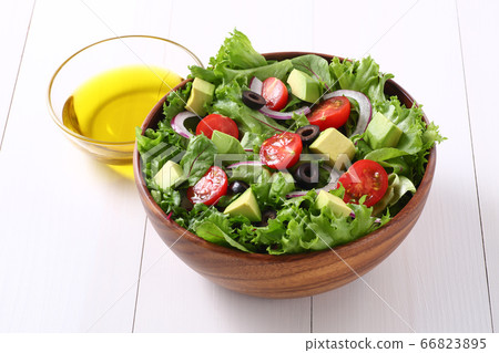 Salad and olive oil 66823895