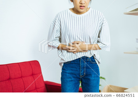 Young woman having painful stomach ache,Women suffering from abdominal pain,Period cramps,Stomach pain 66824551