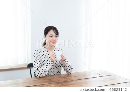 Woman drinking tea at home 66825142