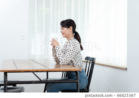 Woman drinking tea at home Woman drinking tea at home 66825367