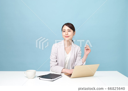 Woman working on a computer at home Woman working on a computer at home 66825640