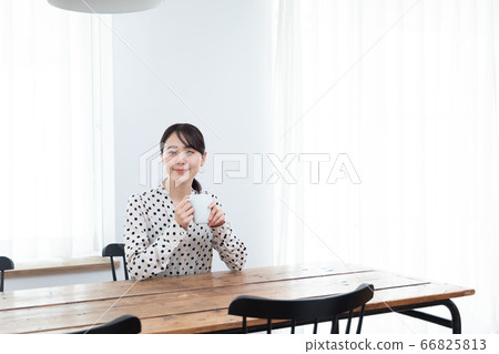 Woman drinking tea at home Woman drinking tea at home 66825813