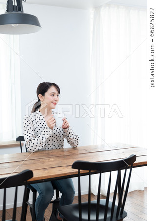 Woman drinking tea at home Woman drinking tea at home 66825822