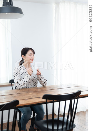 Woman drinking tea at home Woman drinking tea at home 66825823