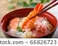 Bowl of rice topped with sashimi  66826723