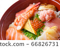 Bowl of rice topped with sashimi  66826731