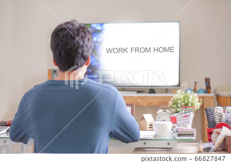 Man wear blue shirt sitting in Living room for work at home. Man wear blue shirt sitting in Living room for work at home. 66827847