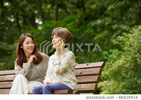 Mother and daughter walking Mother and daughter walking 66829418