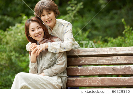 Mother and daughter walking Mother and daughter walking 66829550