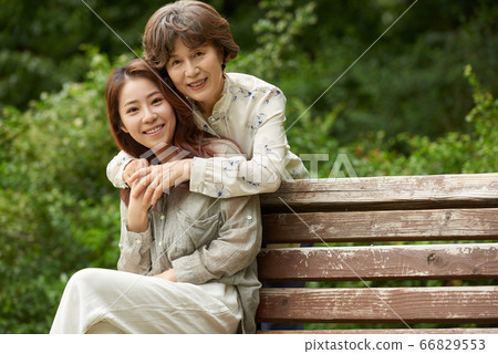 Mother and daughter walking Mother and daughter walking 66829553