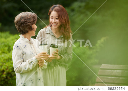 Mother and daughter walking 66829654
