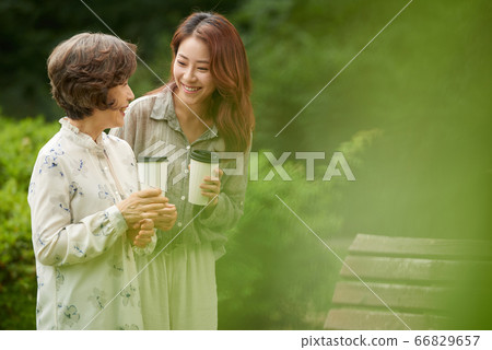 Mother and daughter walking Mother and daughter walking 66829657