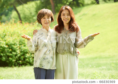 Mother and daughter walking Mother and daughter walking 66830369