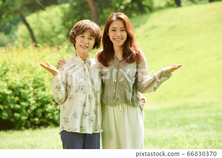 Mother and daughter walking 66830370