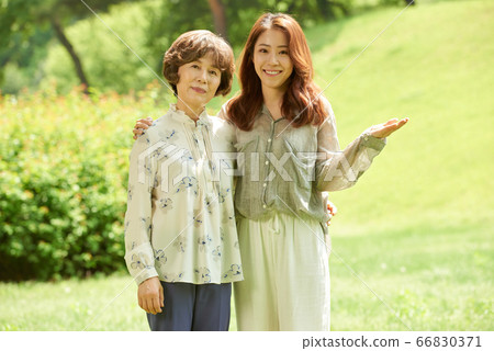 Mother and daughter walking 66830371