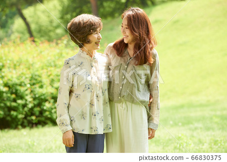 Mother and daughter walking Mother and daughter walking 66830375