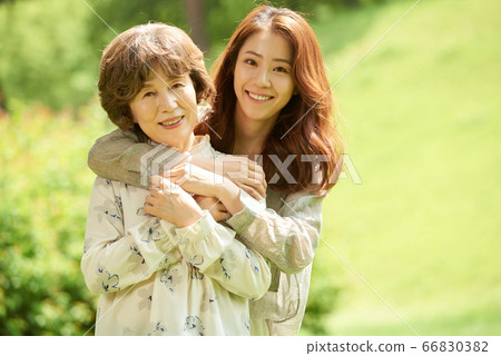 Mother and daughter walking Mother and daughter walking 66830382