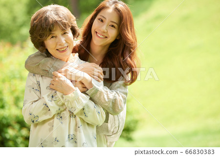 Mother and daughter walking 66830383