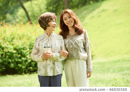Mother and daughter walking Mother and daughter walking 66830388