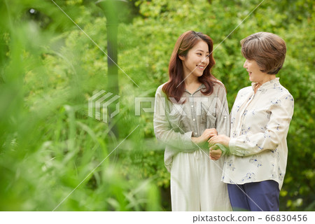 Mother and daughter walking Mother and daughter walking 66830456