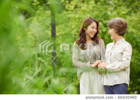 Mother and daughter walking 66830460