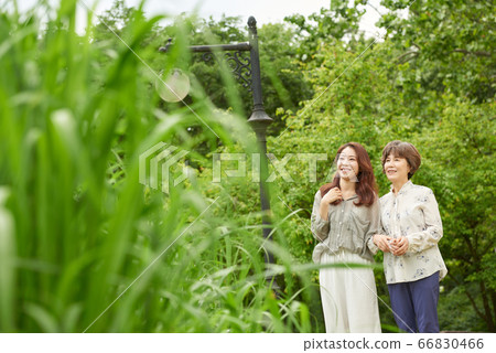 Mother and daughter walking 66830466