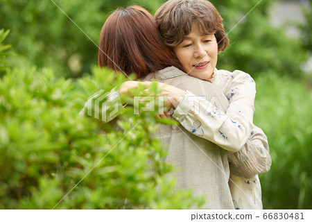 Mother and daughter walking 66830481