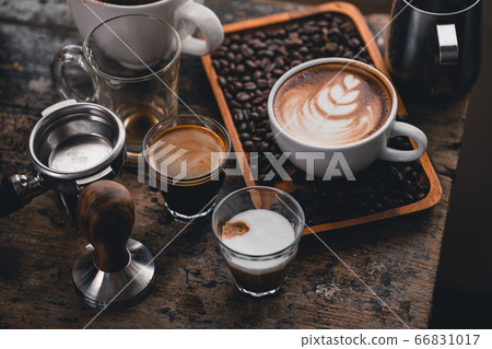 Latte coffee in a cup on the table at home Latte coffee in a cup on the table at home 66831017
