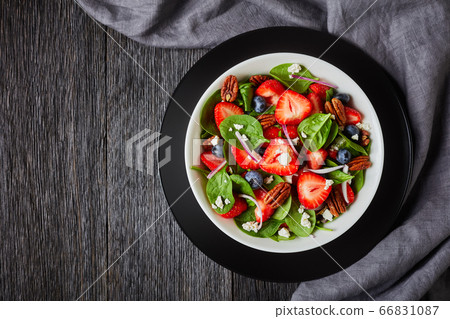 berry spinach salad with nuts and crumbled feta berry spinach salad with nuts and crumbled feta 66831087