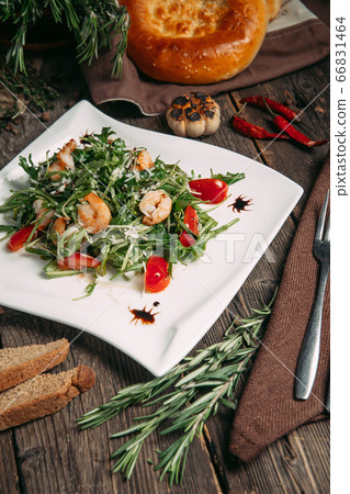 Closeup on arugula shrimps and tomatoes salad 66831464