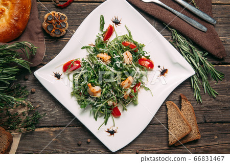Top view on arugula shrimps and tomatoes salad Top view on arugula shrimps and tomatoes salad 66831467