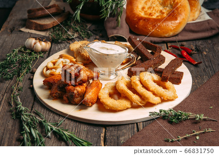 Side view on beer snacks set on the wooden board Side view on beer snacks set on the wooden board 66831750