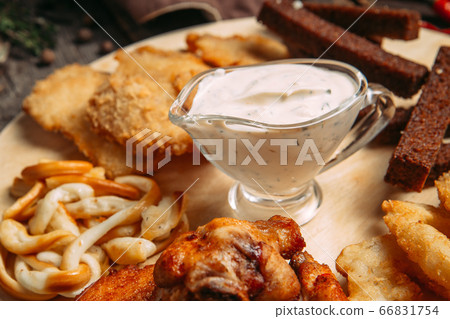 Closeup on beer snacks set on the wooden board Closeup on beer snacks set on the wooden board 66831754