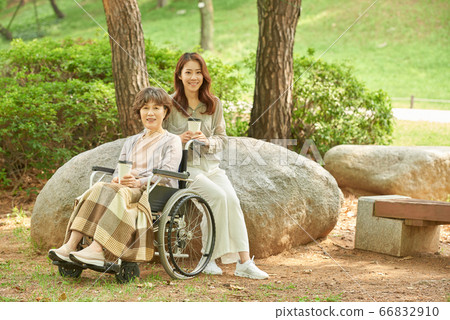 Mother and daughter walking Mother and daughter walking 66832910