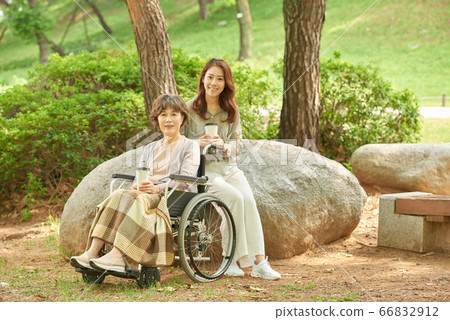 Mother and daughter walking Mother and daughter walking 66832912