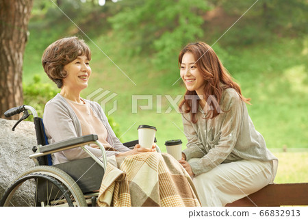 Mother and daughter walking Mother and daughter walking 66832913