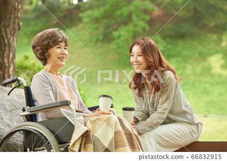 Mother and daughter walking Mother and daughter walking 66832915