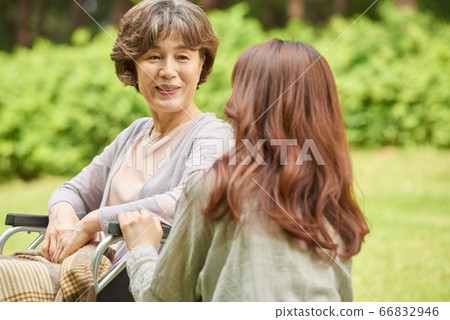 Mother and daughter walking Mother and daughter walking 66832946